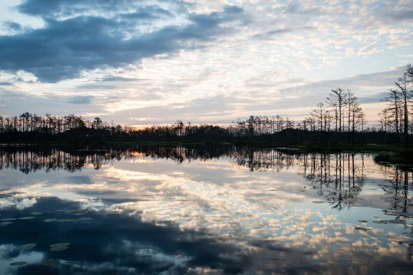 Reflektioner i sjön vattnet vid soluppgången — Stockfoto