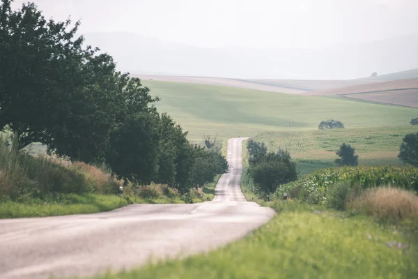 Mountain country road in summer - vintage film effect — Stock Photo, Image