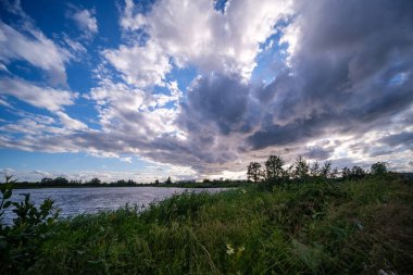 Yazın mavi suyla deniz limanı üzerinde dramatik fırtına bulutları