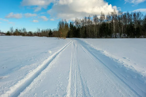 tourist trail in winter snow with boot tracks and steps