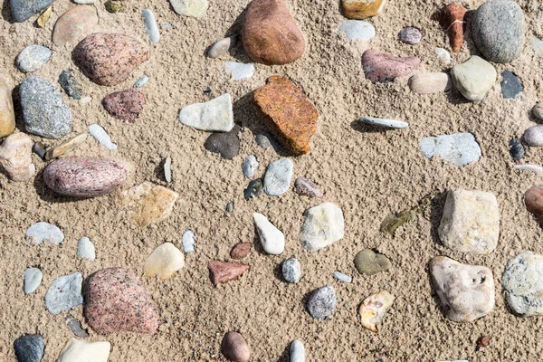 Rocky beach with sand and pebbles — Stock Photo, Image