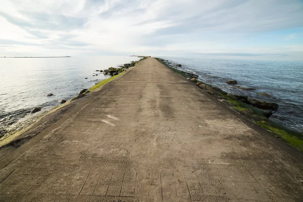 Breakwater in the sea with lighthouse on it — Stock Photo, Image