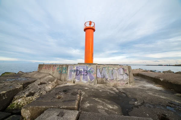 Breakwater in the sea with lighthouse on it — Stock Photo, Image