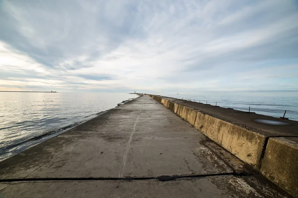 Breakwater in the sea with lighthouse on it — Stock Photo, Image