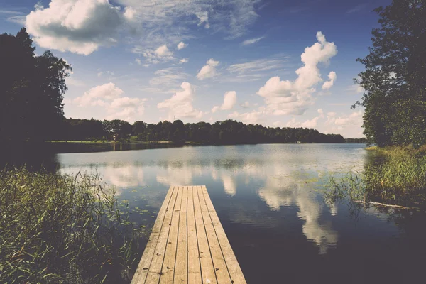 Reflection of clouds in the lake with boardwalk. Vintage. — Stock Photo, Image