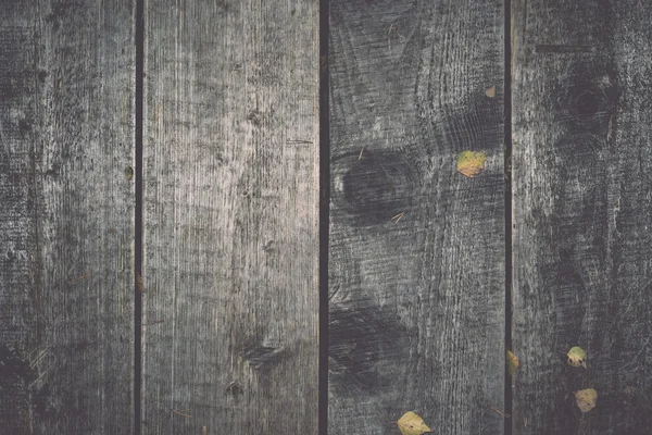 Old wooden planks covered with leaves. Vintage. — Stock Photo, Image