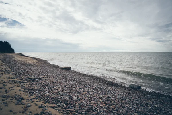 Praia rochosa no mar baltico. Retro olhar filme granulado . — Fotografia de Stock