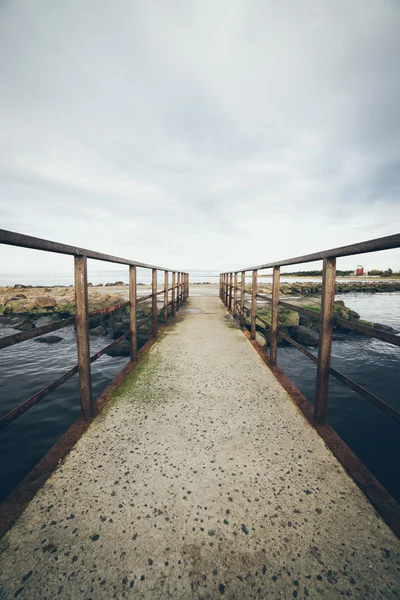 Old bridge with rusty metal rails. Retro grainy film look. — Stock Photo, Image