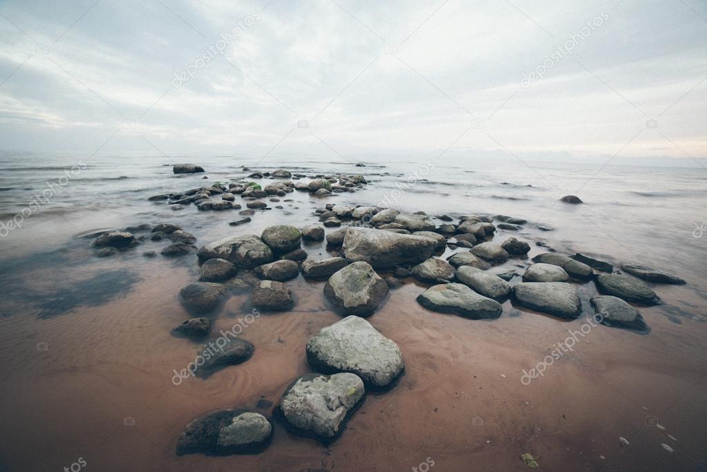 rocky sea beach with wide angle perspective. Retro grainy film l