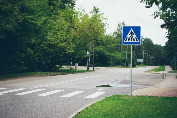 Road signs and lines on asphalt. Retro grainy film look. — Stock Photo, Image