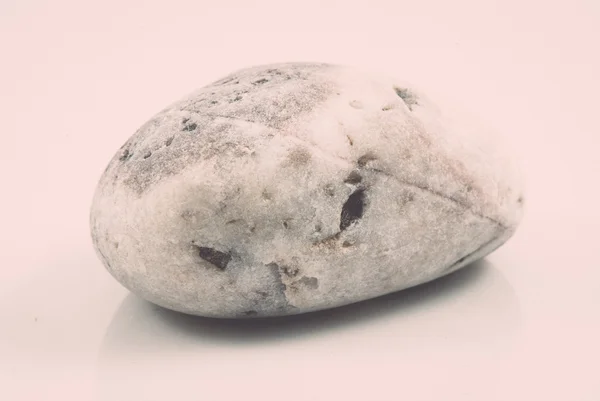 Één steen geïsoleerd op een witte achtergrond. Vintage — Stockfoto