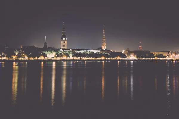 Summer night city light reflections over water - retro, vintage — Stock Photo, Image