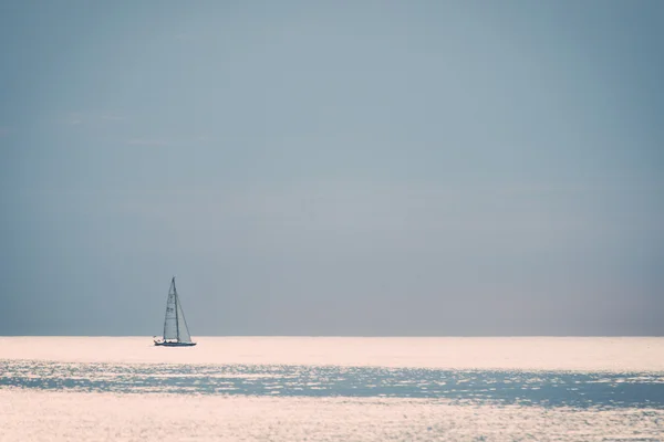 Small boat in the sea at sunrise - retro, vintage — Stock Photo, Image