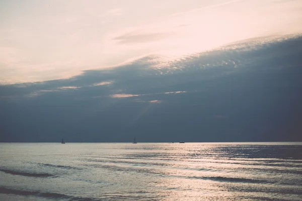 Small boat in the sea at sunrise - retro, vintage — Stock Photo, Image