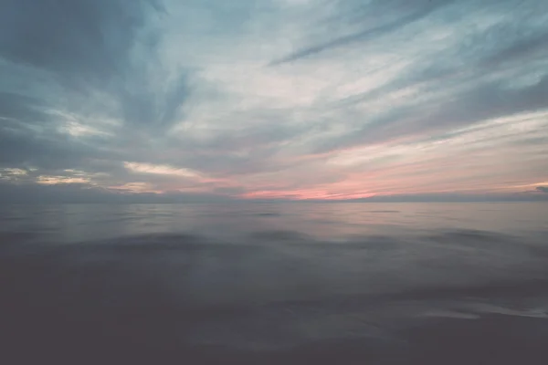 Long exposure dramatic blue sunset with washed out waves - retro — Stock Photo, Image