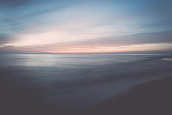Larga exposición dramática puesta de sol azul con las olas lavadas - retro — Foto de Stock