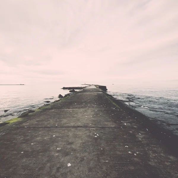 Breakwater in the sea with lighthouse on it - retro, vintage — Stock Photo, Image