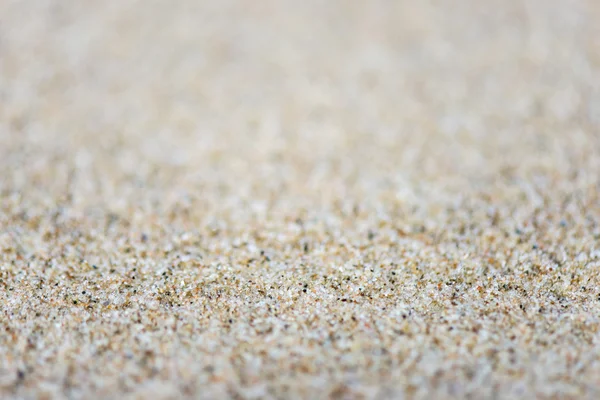 Textura de fundo de areia com profundidade de campo rasa — Fotografia de Stock