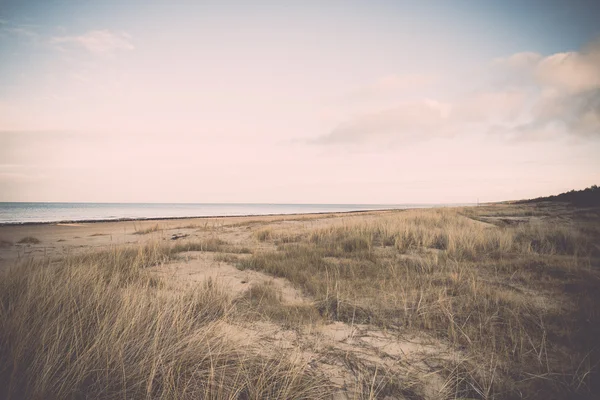Baltic beach in fall with clouds and waves towards deserted dune — Stock Photo, Image