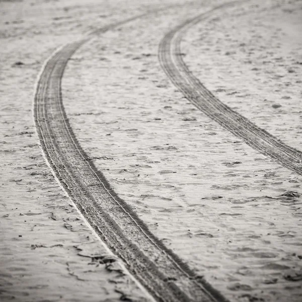 car tyre tracks on the beach sand - retro vintage look