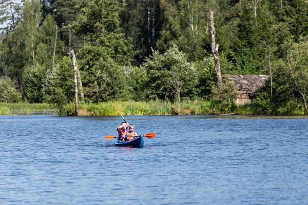 tourists enjoying water sports, kayaking