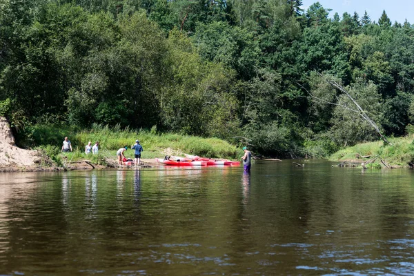 tourists enjoying water sports, kayaking