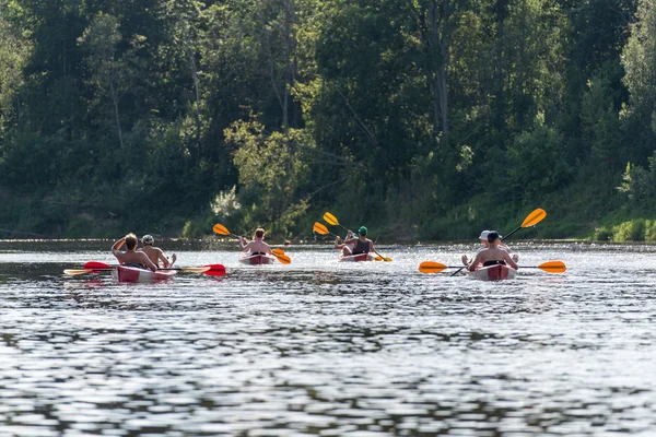tourists enjoying water sports, kayaking