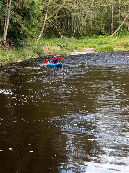 tourists enjoying water sports, kayaking