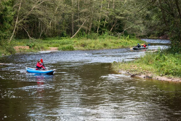 tourists enjoying water sports, kayaking