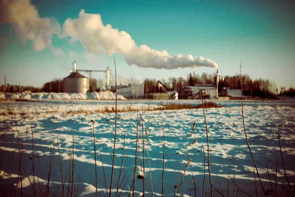 industrial park with chimney and white smoke - retro vintage