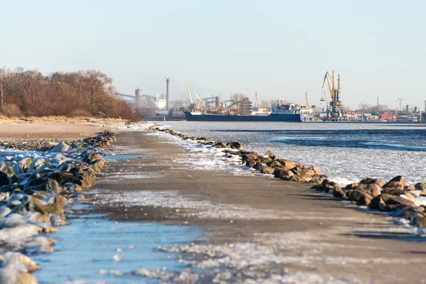 Zugefrorener Strand in der Nähe von Werft und Seehafen — Stockfoto