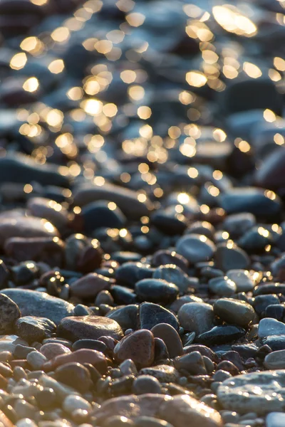 Stones on beach and sea water — Stock Photo, Image