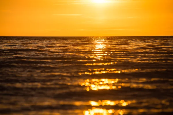 Orange dramatic sunset on the sea beach — стоковое фото