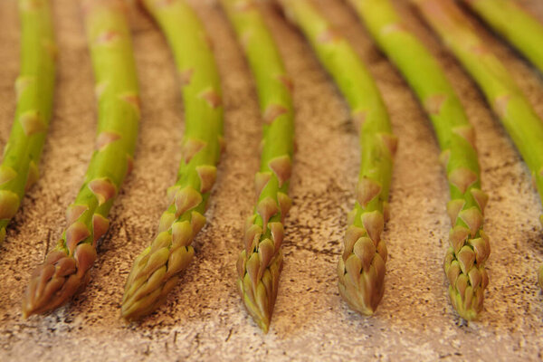Fresh green asparagus on a brown background. Top view image. 