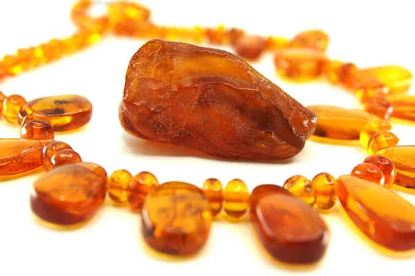 Necklace made of natural amber isolated on a white background. Piece of yellow translucent Baltic amber in the middle. Beautiful jewellery for woman