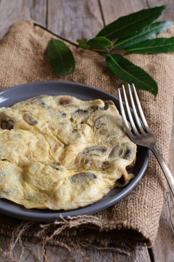 Çuval bezi ve kırsal masada mantarlı omlet.