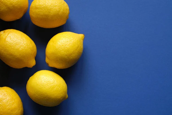 Mavi arka planda taze olgun limonlar. Üst görünüm.