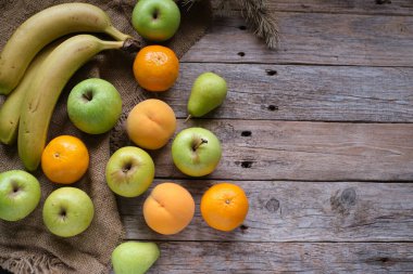 Kırsal ahşap masada çeşitli meyvelerle arka plan ve boşluğu kopyala