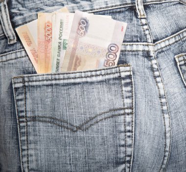 Russian rubles stick out of a hip-pocket of jeans