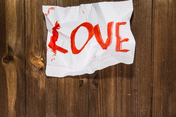 The word love written on the crumpled standard sheet which is pu — Stok fotoğraf