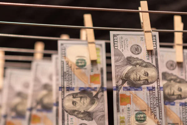 Money laundering on clothesline. Money Laundering US dollars hung out to dry. 100 dollar bills hanging on clotheslines. Shallow dof