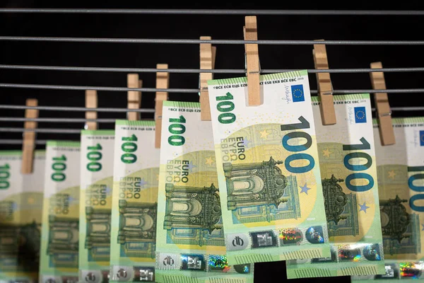Euro notes on clothesline. Money laundering on clothesline. Money Laundering euro hung out to dry. Euro bills hanging on clotheslines. Shallow dof