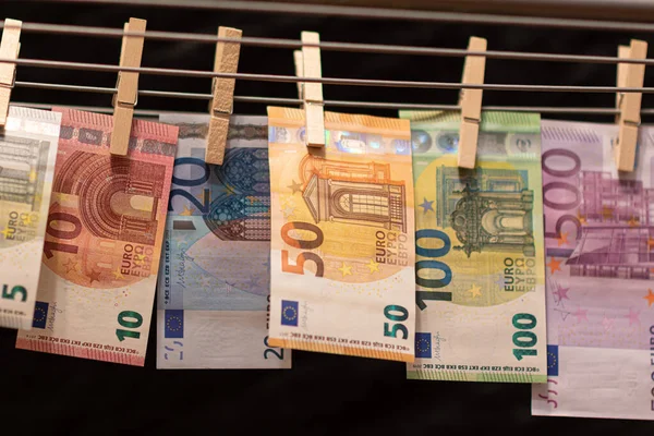 Euro notes on clothesline. Money laundering on clothesline. Money Laundering euro hung out to dry. Euro bills hanging on clotheslines. Shallow dof