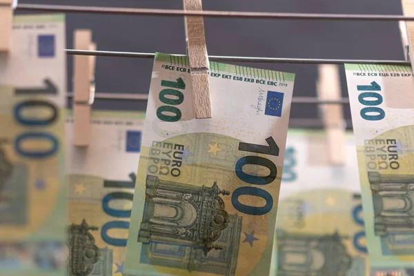 Euro notes on clothesline. Money laundering on clothesline. Money Laundering euro hung out to dry. Euro bills hanging on clotheslines. Shallow dof