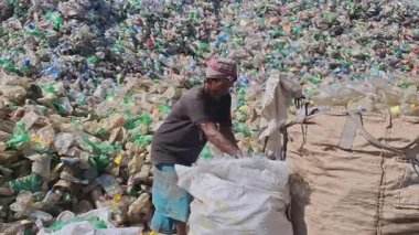 Bangladeş 'in Chittagong şehrinde atık plastik şişe imha alanında çalışan insanlar. Doğayı, kirliliği, chittagong, Bangladeş 'i kurtar