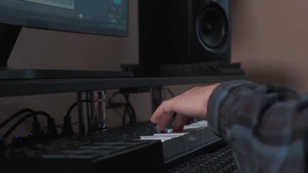 Male hands playing electronic keyboard, midi keys on the table. — Stock Video