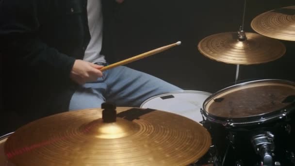 Drummer playing the drum set in a dark room on a black background. — Stock Video