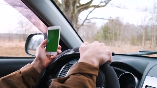 Młody mężczyzna podróżuje samochodem, korzystając z nawigacji i map w lesie. Zielony ekran — Wideo stockowe