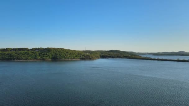 Aerial birds following view of a hige river bay and the green rainforest under the setting sun. — Stock Video