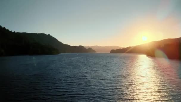 Birds-eye view of the sunrise over the river with hilly terrain. — Stock Video